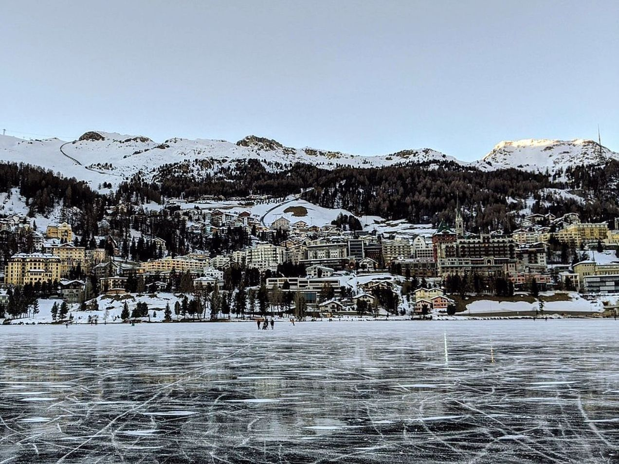 Pradera alpina junto a un lago bajo el hielo en invierno